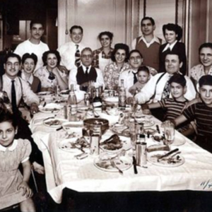 Historic photo of large family gathered around a table.